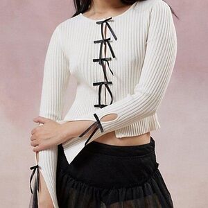 White sweater with black bows